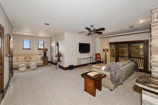 living room with light carpet and ceiling fan