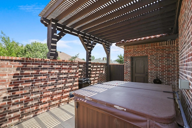 view of patio / terrace featuring a hot tub and a pergola