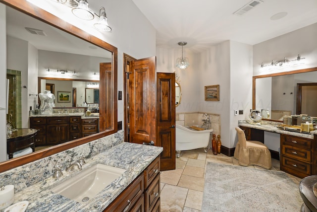 bathroom featuring vanity and a bath