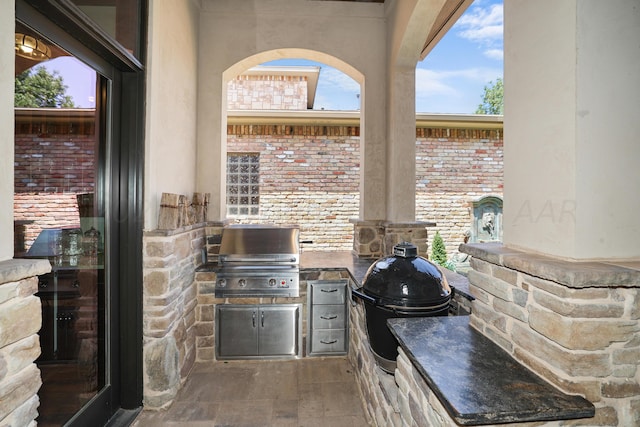 view of patio / terrace featuring an outdoor kitchen and a grill