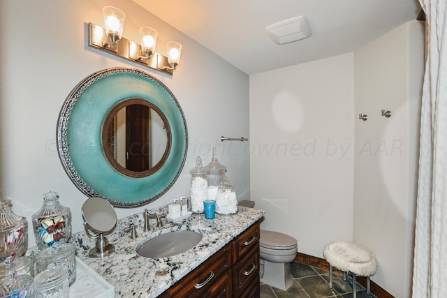 bathroom with vanity, tile patterned floors, and toilet