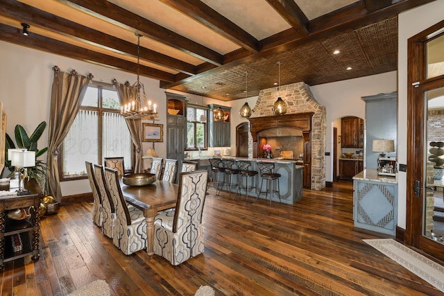 dining room featuring arched walkways, dark wood-type flooring, beamed ceiling, and an inviting chandelier