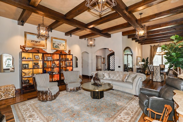 living room featuring wood-type flooring, a notable chandelier, and beam ceiling