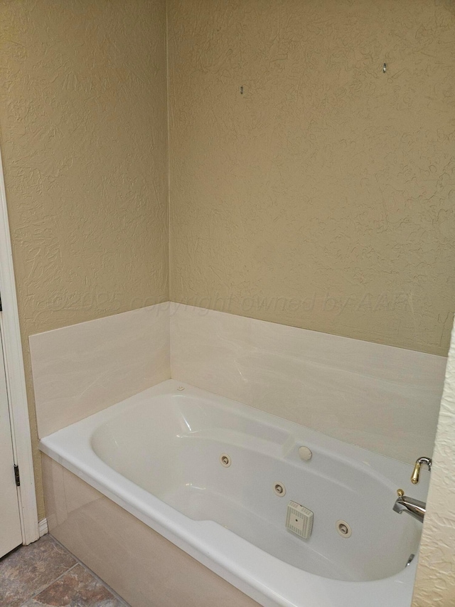 7205 Columbia Ln, Amarillo, TX 79109 - full bathroom with a tub with jets and a textured wall