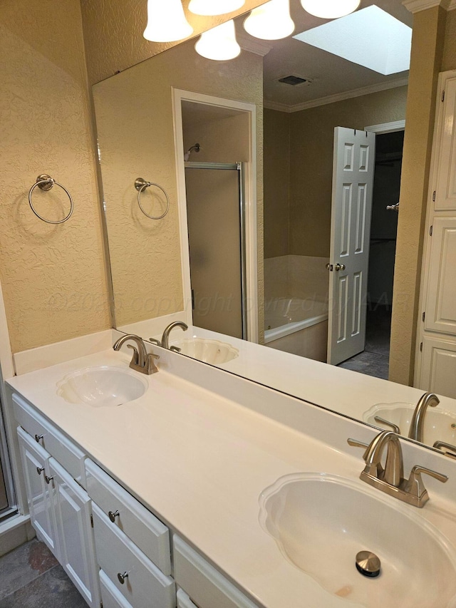7205 Columbia Ln, Amarillo, TX 79109 - full bath with double vanity, a textured wall, a garden tub, a stall shower, and crown molding