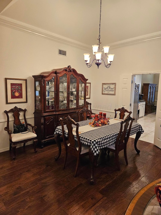 7205 Columbia Ln, Amarillo, TX 79109 - dining area featuring a chandelier, ornamental molding, and wood finished floors