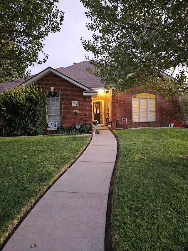 7205 Columbia Ln, Amarillo, TX 79109 - single story home with brick siding, a front yard, and a shingled roof