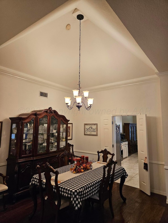 7205 Columbia Ln, Amarillo, TX 79109 - dining area featuring high vaulted ceiling, a chandelier, crown molding, and wood finished floors