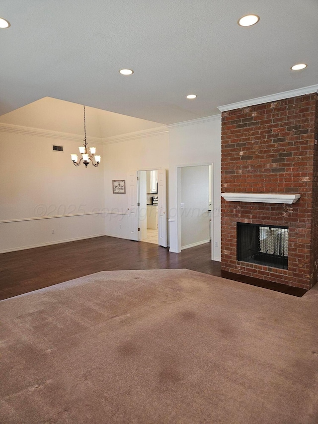 7205 Columbia Ln, Amarillo, TX 79109 - unfurnished living room featuring crown molding, a chandelier, a fireplace, dark wood finished floors, and recessed lighting