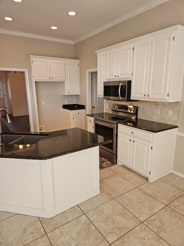 7205 Columbia Ln, Amarillo, TX 79109 - kitchen with stainless steel appliances, white cabinets, decorative backsplash, recessed lighting, and light tile patterned flooring