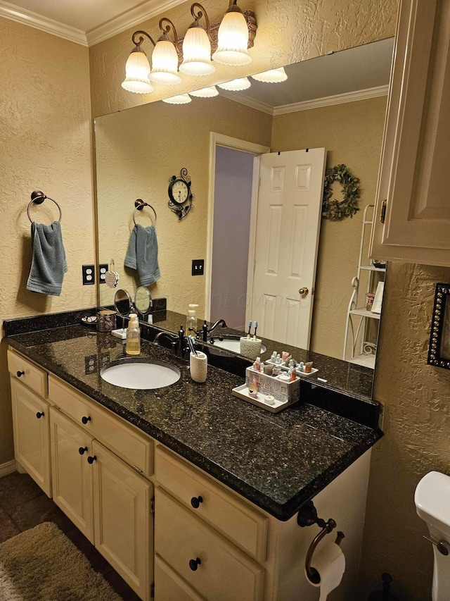 7205 Columbia Ln, Amarillo, TX 79109 - bathroom featuring a textured wall, ornamental molding, and vanity