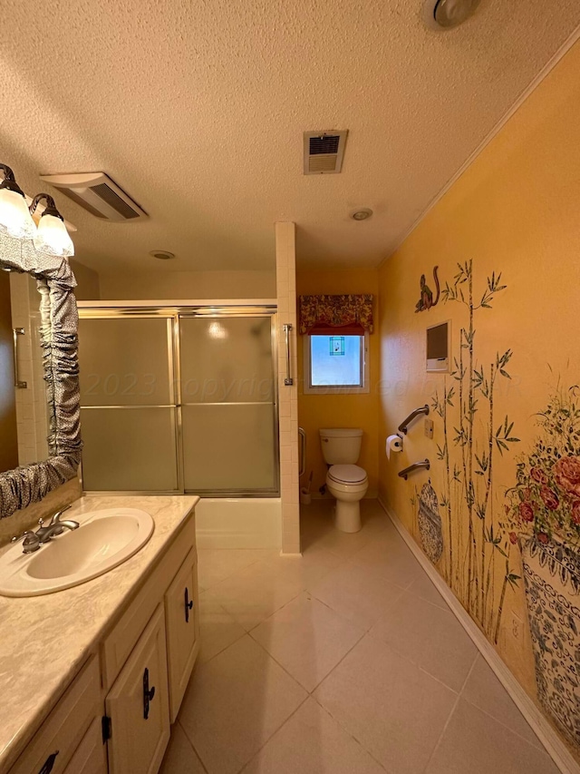 full bathroom featuring tile patterned flooring, vanity, a textured ceiling, and toilet