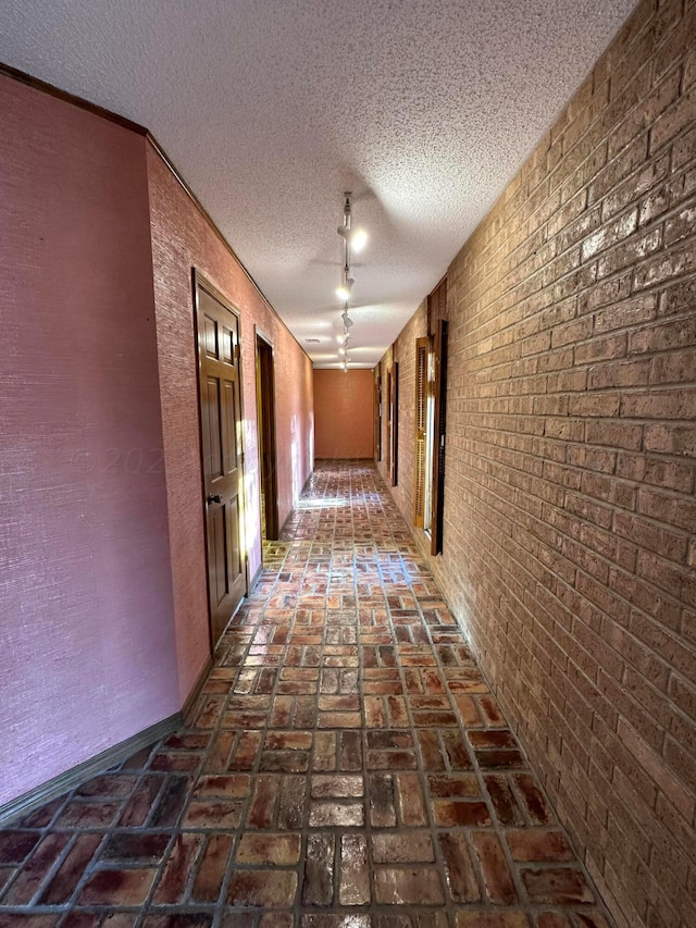 hallway with a textured ceiling