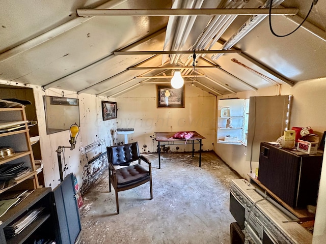 sitting room featuring vaulted ceiling and concrete floors