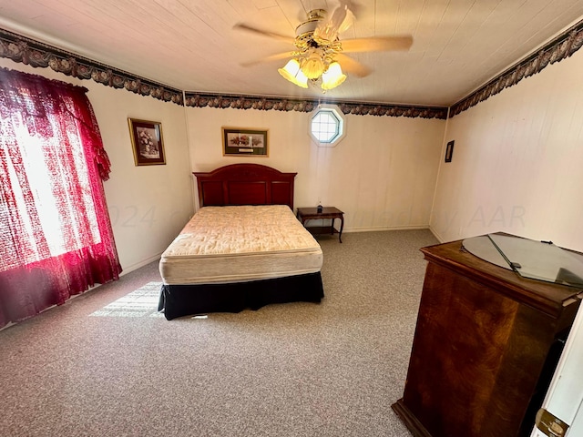 carpeted bedroom with wooden ceiling and ceiling fan