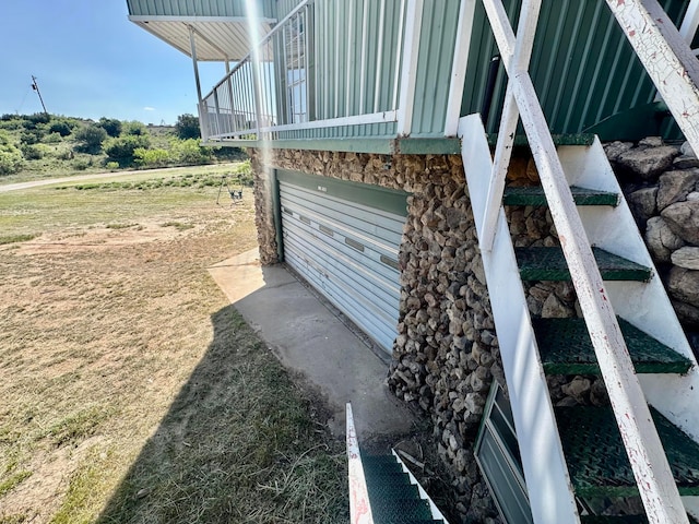 view of property exterior featuring a balcony and a garage