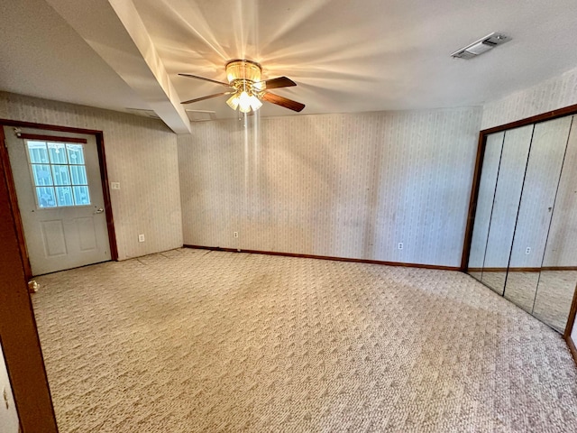 interior space with carpet flooring and ceiling fan