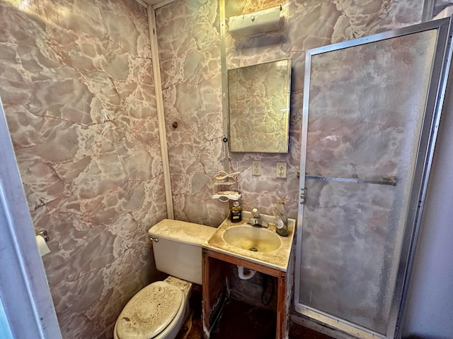 bathroom with toilet, vanity, and tile walls