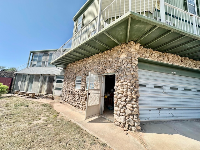 exterior space with a garage and a balcony