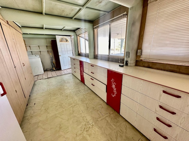 kitchen with wooden walls and washer / dryer