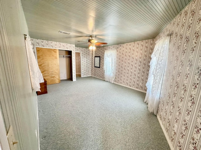 unfurnished bedroom with a closet, ceiling fan, and carpet floors