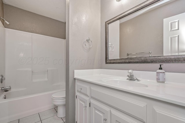 bathroom with toilet, tile patterned floors, vanity,  shower combination, and a textured wall