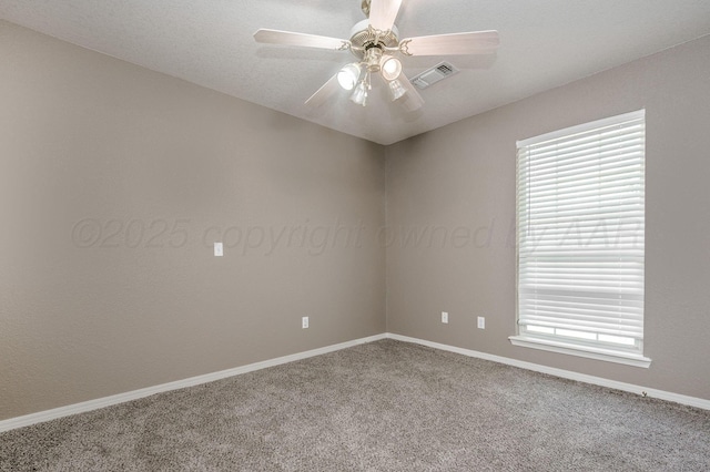 empty room featuring carpet floors, a ceiling fan, and baseboards
