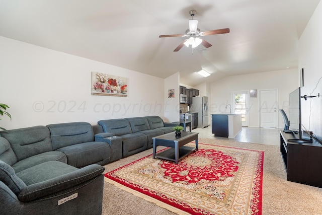 carpeted living room featuring ceiling fan, sink, and lofted ceiling