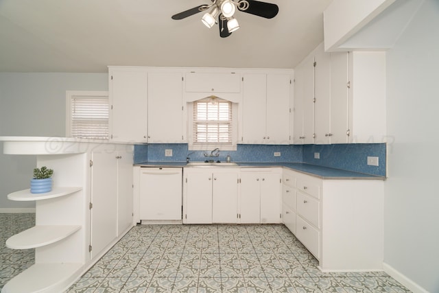 kitchen with sink, white cabinets, decorative backsplash, ceiling fan, and white dishwasher