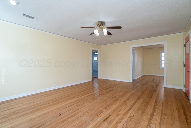 unfurnished room with ceiling fan, light hardwood / wood-style flooring, and a textured ceiling