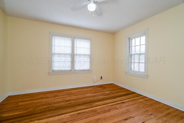 spare room featuring ceiling fan and hardwood / wood-style floors