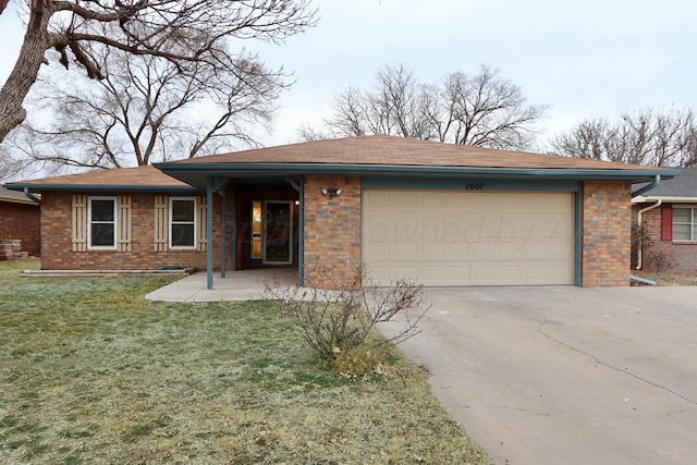 single story home featuring a garage, brick siding, driveway, and a front lawn