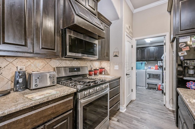 7402 Southbend Dr, Amarillo, TX 79119 - kitchen featuring stainless steel appliances, crown molding, washing machine and dryer, dark brown cabinetry, and tasteful backsplash
