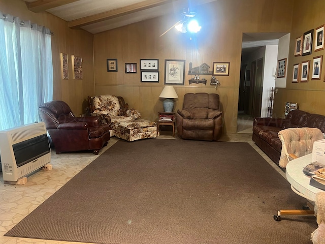 living room with lofted ceiling with beams, ceiling fan, wooden walls, and heating unit