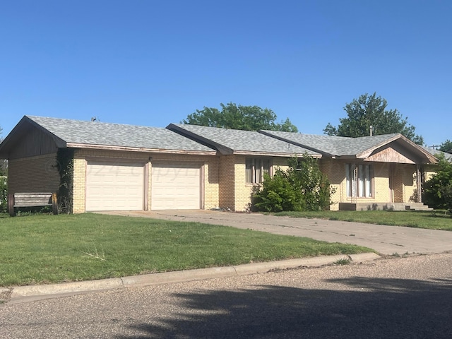 ranch-style house featuring a garage and a front lawn