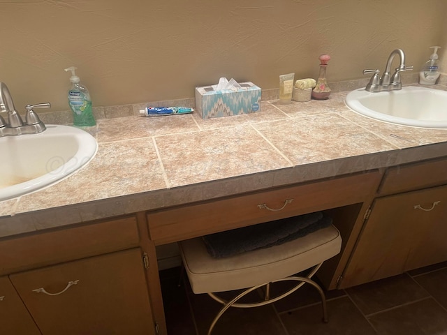 bathroom with tile patterned flooring and vanity