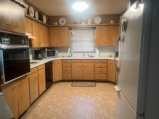 kitchen featuring black appliances and sink