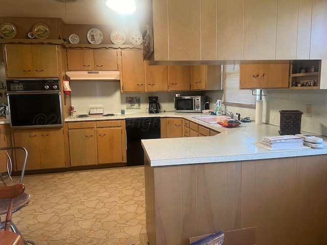 kitchen featuring black appliances, decorative backsplash, kitchen peninsula, and sink