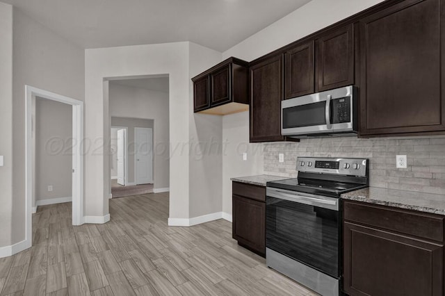 9110 Lexford Dr, Amarillo, TX 79119 - kitchen with appliances with stainless steel finishes, backsplash, dark brown cabinets, light stone counters, and light wood-type flooring