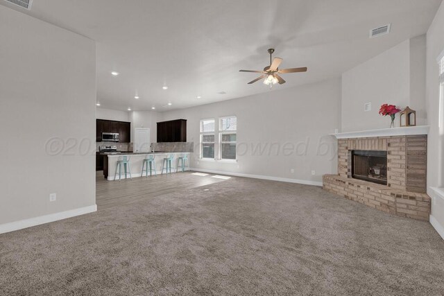 9110 Lexford Dr, Amarillo, TX 79119 - unfurnished living room with carpet flooring, ceiling fan, recessed lighting, and a fireplace