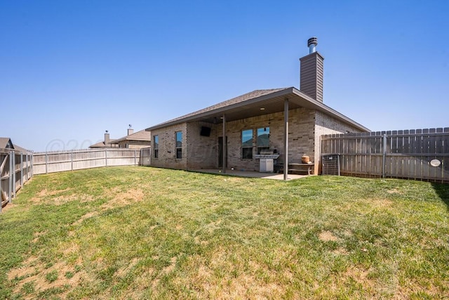 9110 Lexford Dr, Amarillo, TX 79119 - rear view of property featuring brick siding, a chimney, a fenced backyard, and a patio area