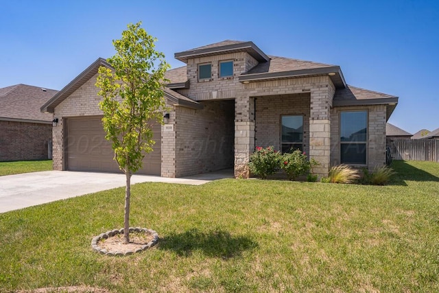 9110 Lexford Dr, Amarillo, TX 79119 - view of front of home with a garage, driveway, brick siding, and a shingled roof
