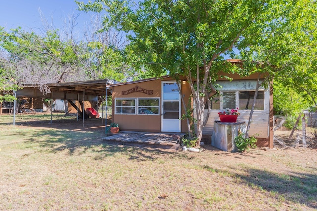 back of house with a yard and a carport