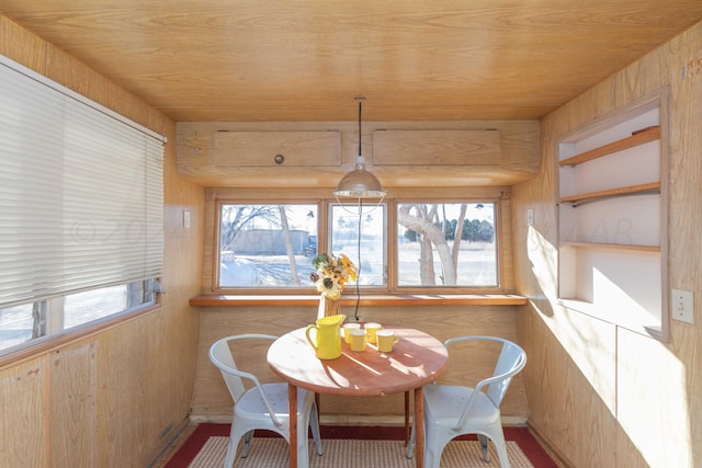 sunroom featuring wooden ceiling and a healthy amount of sunlight