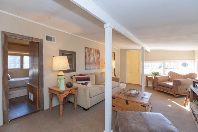 carpeted living room with crown molding and beam ceiling