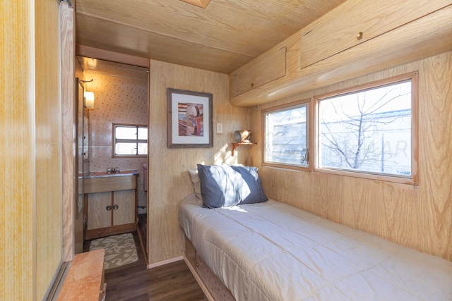 bedroom featuring wood walls, dark hardwood / wood-style floors, and wood ceiling