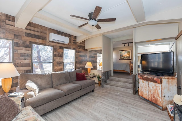 living room featuring an AC wall unit, vaulted ceiling with beams, light wood-type flooring, wooden walls, and ceiling fan