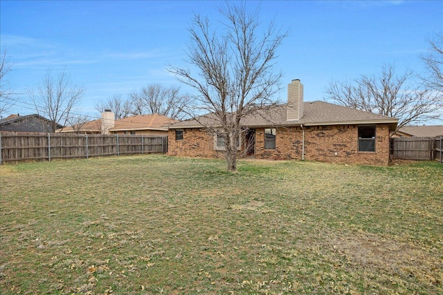 rear view of property featuring a lawn