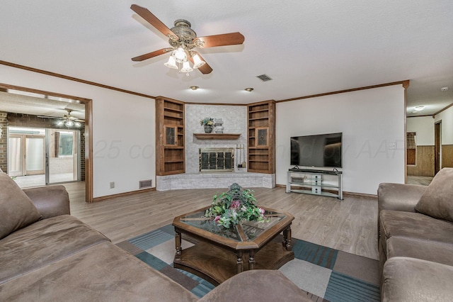 613 Bennett Dr, Dumas, TX 79029 - living area with a ceiling fan, baseboards, ornamental molding, wood finished floors, and a fireplace
