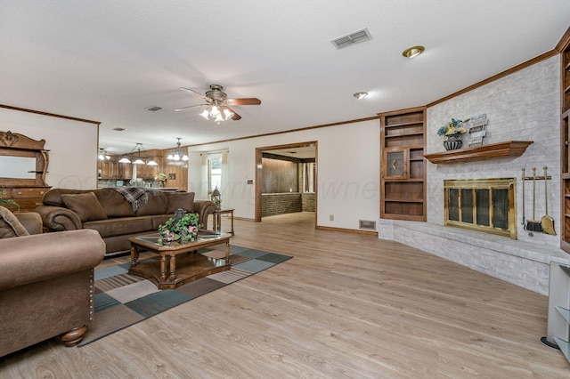 613 Bennett Dr, Dumas, TX 79029 - living area featuring a ceiling fan, light wood-style flooring, crown molding, a brick fireplace, and baseboards